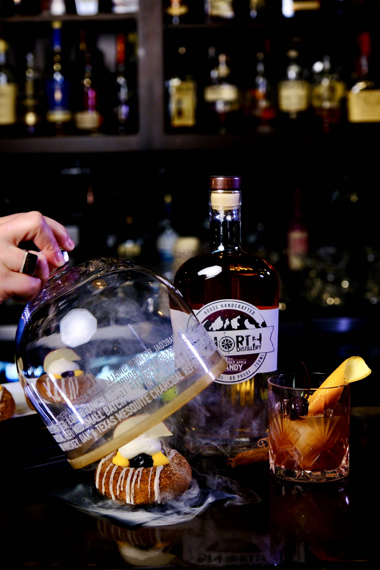 A Lantern donut beside an Up North Distillery bottle and a cocktail